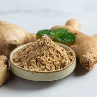 gingembre râpé dans un ramequin et gingembre naturel entier